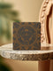 Square ceramic coaster featuring a detailed copper dragonfly design centered in a medallion, surrounded by moon phases and Art Nouveau patterns on a charcoal black background, with cork backing.
